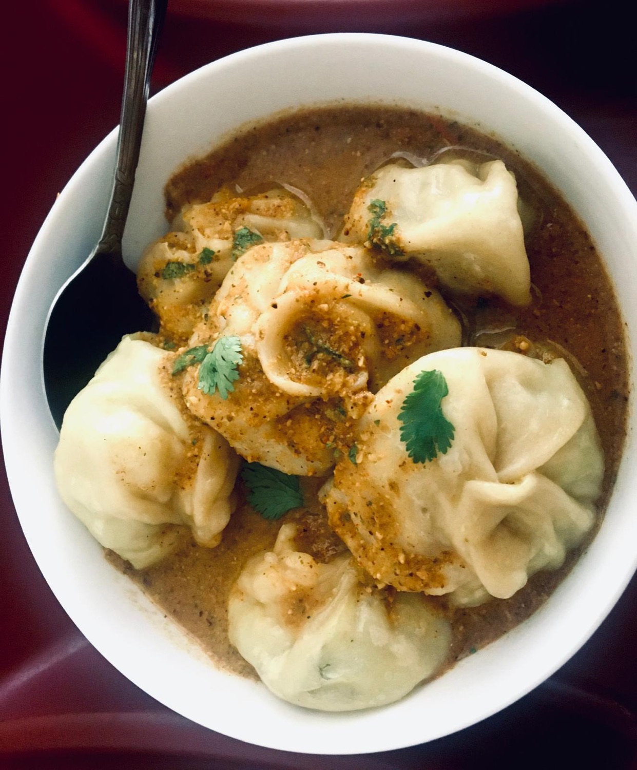 Momos in spiced jhol sauce